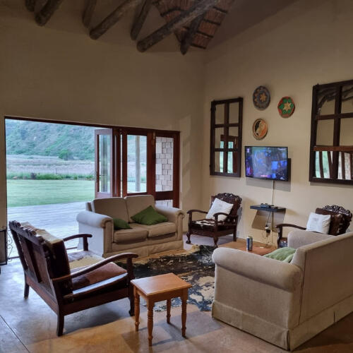Living Room at Plain Champagne Guest Farm Comfortable living room at Plain Champagne Guest Farm with couches, mountain views, and doors opening to the deck
